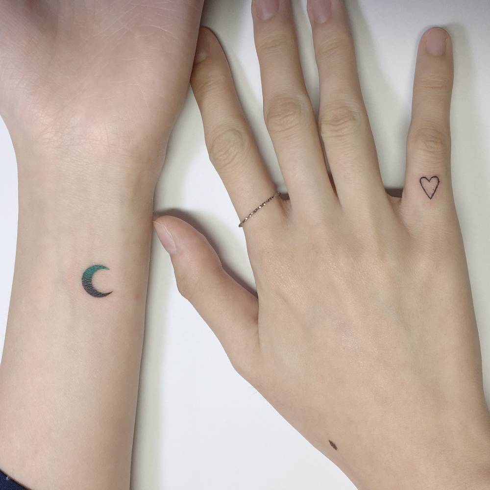 Spectrum moon and minimalistic heart tattoos.