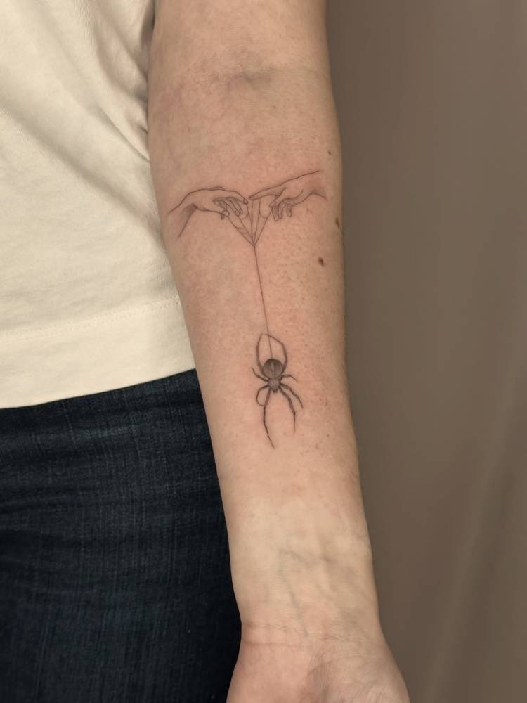 Hands and spider tattoo located on the inner forearm, illustrative style.