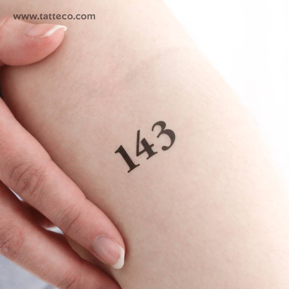 Serif font number "143" temporary tattoo located on the inner forearm.