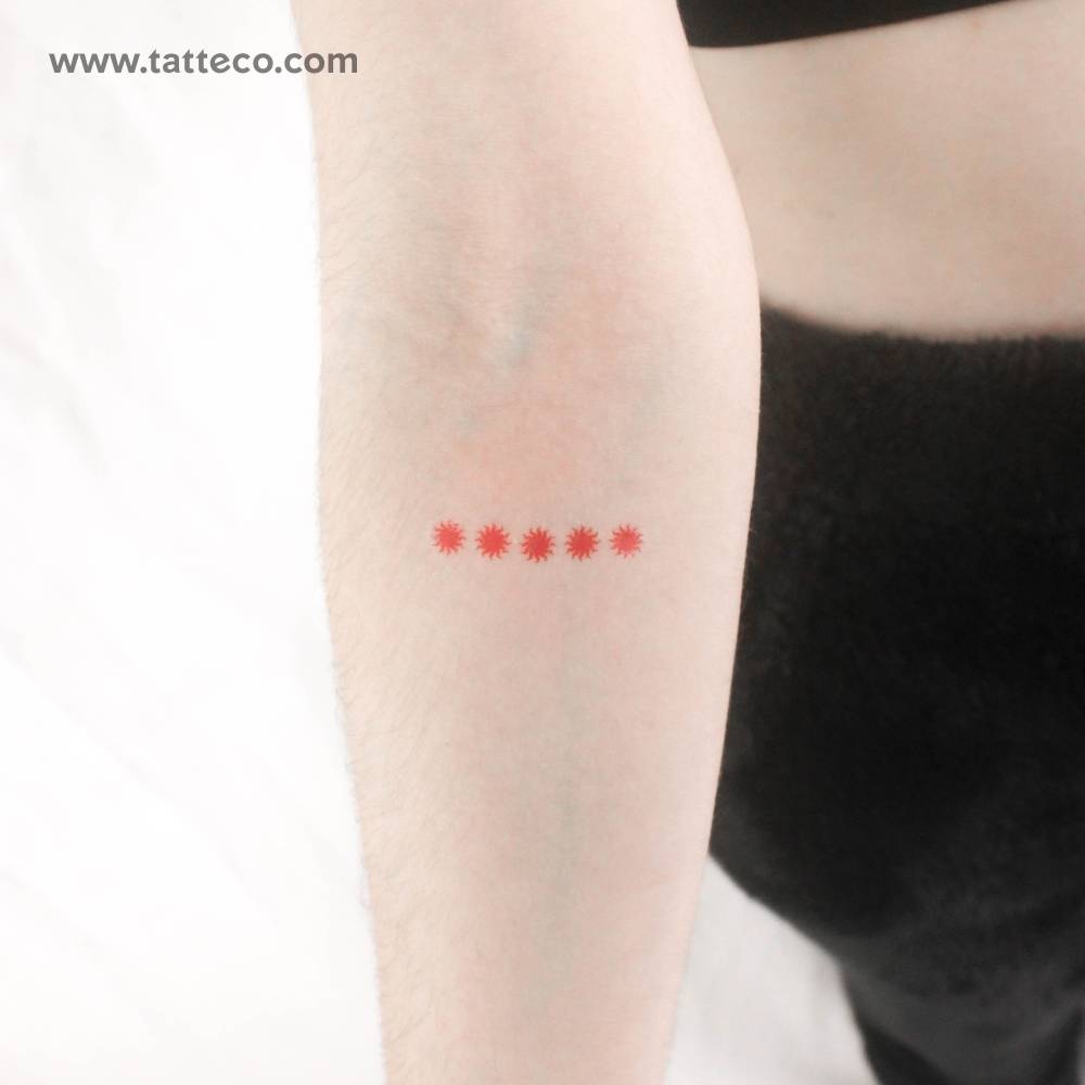 Five red suns temporary tattoo located on the inner forearm.
