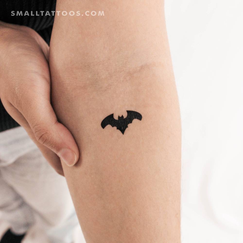 Bat temporary tattoo located on the inner forearm, minimalistic style.