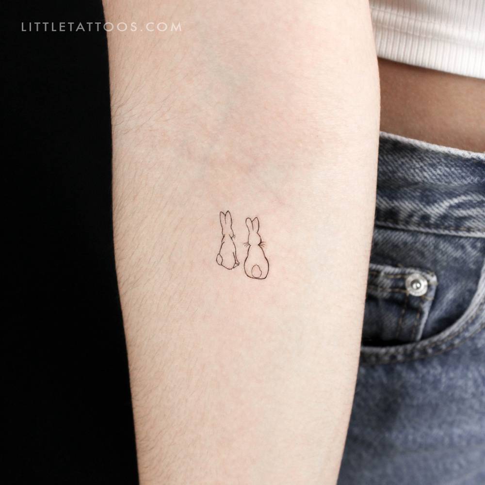 Rabbit couple temporary tattoo located on the inner forearm.