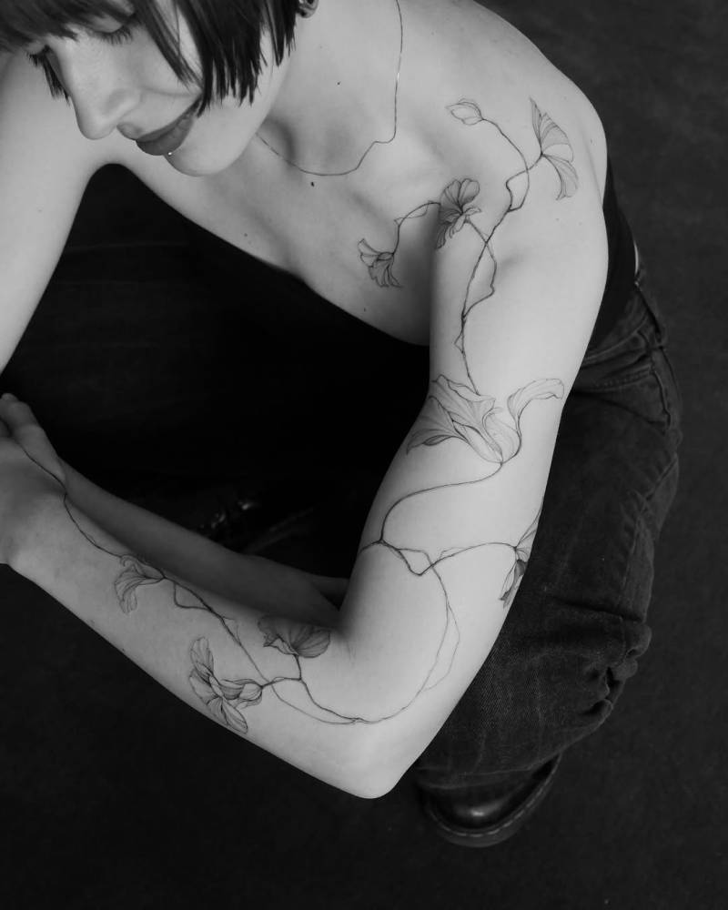 Nasturtium tattoo in illustrative style located on the arm.