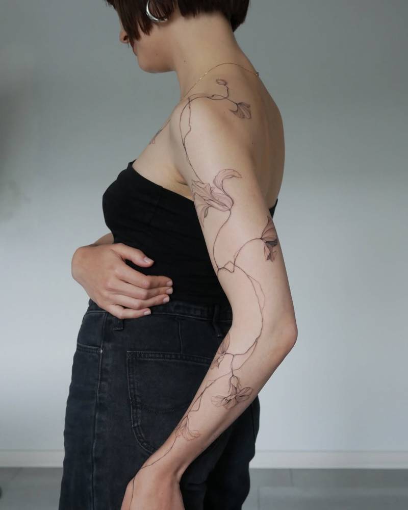 Nasturtium tattoo in illustrative style located on the arm.