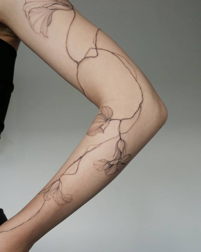 Nasturtium tattoo in illustrative style located on the arm.