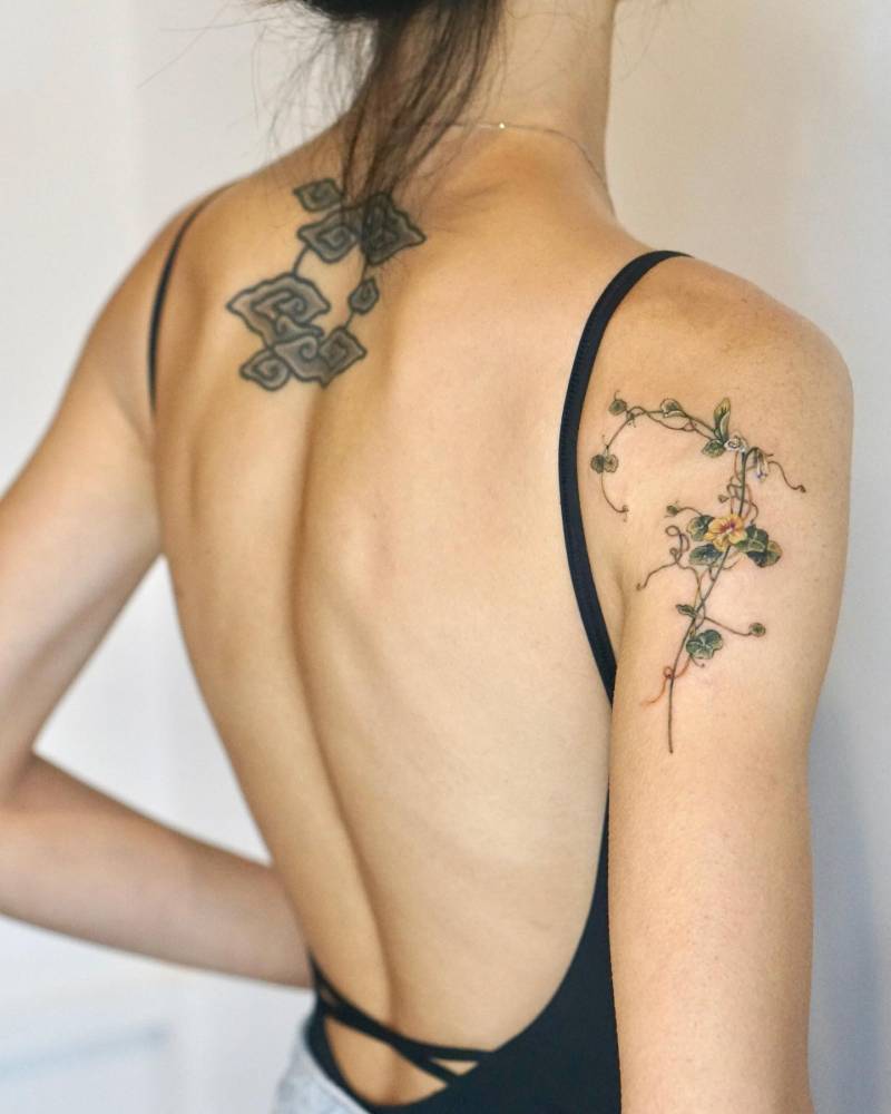 Nasturtium vines tattooed on the upper arm.