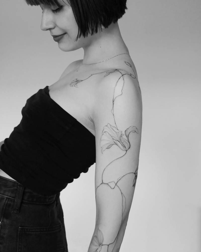 Nasturtium tattoo in illustrative style located on the arm.