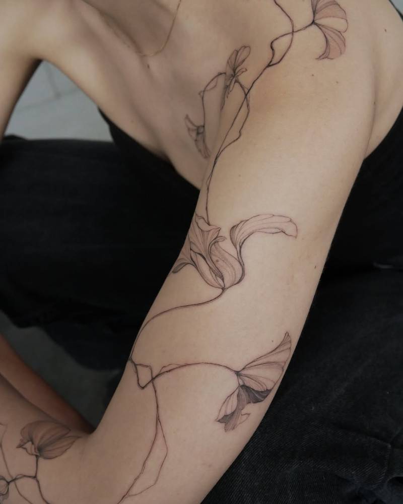 Nasturtium tattoo in illustrative style located on the arm.