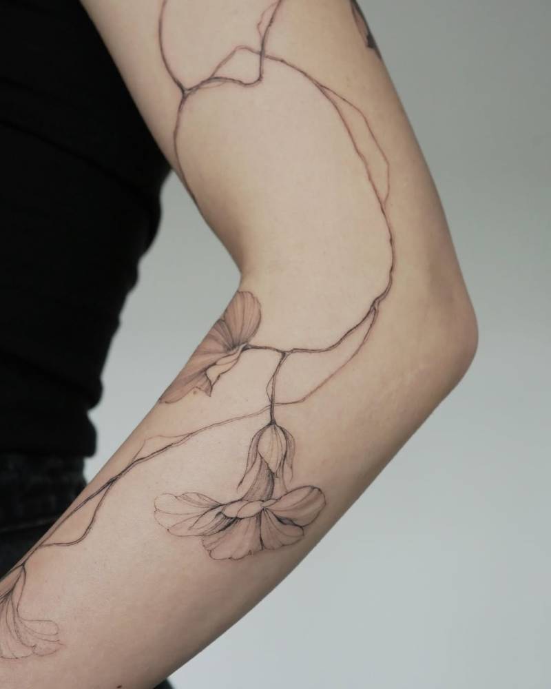 Nasturtium tattoo in illustrative style located on the arm.