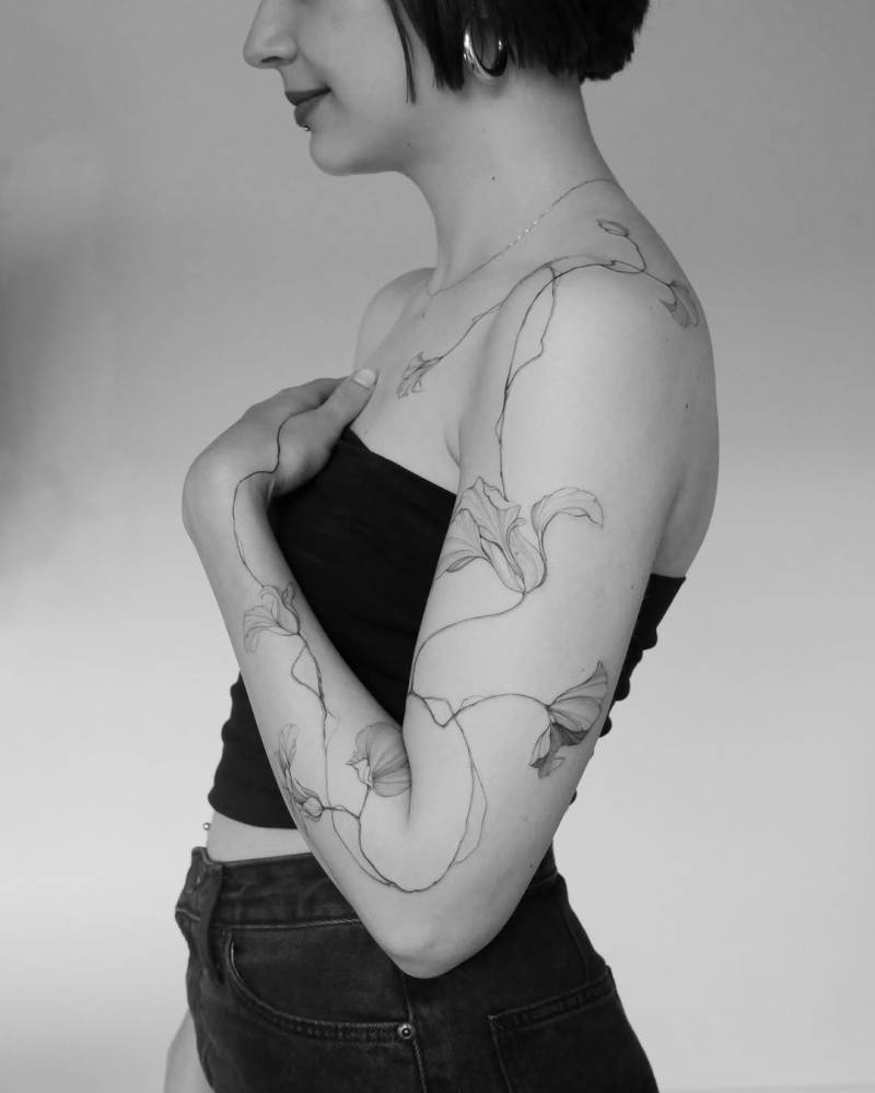 Nasturtium tattoo in illustrative style located on the arm.