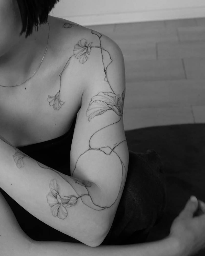 Nasturtium tattoo in illustrative style located on the arm.