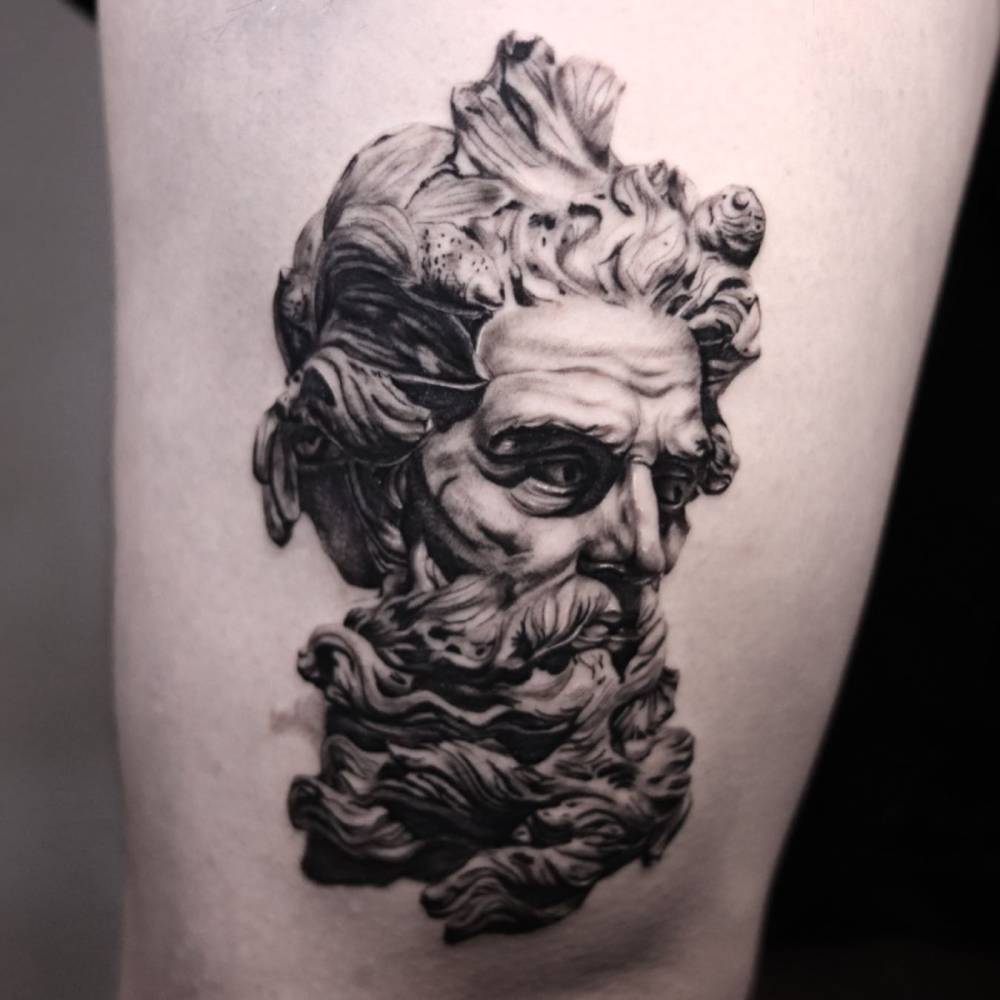 'Bust of Neptune' tattoo located on the thigh, black and grey style.