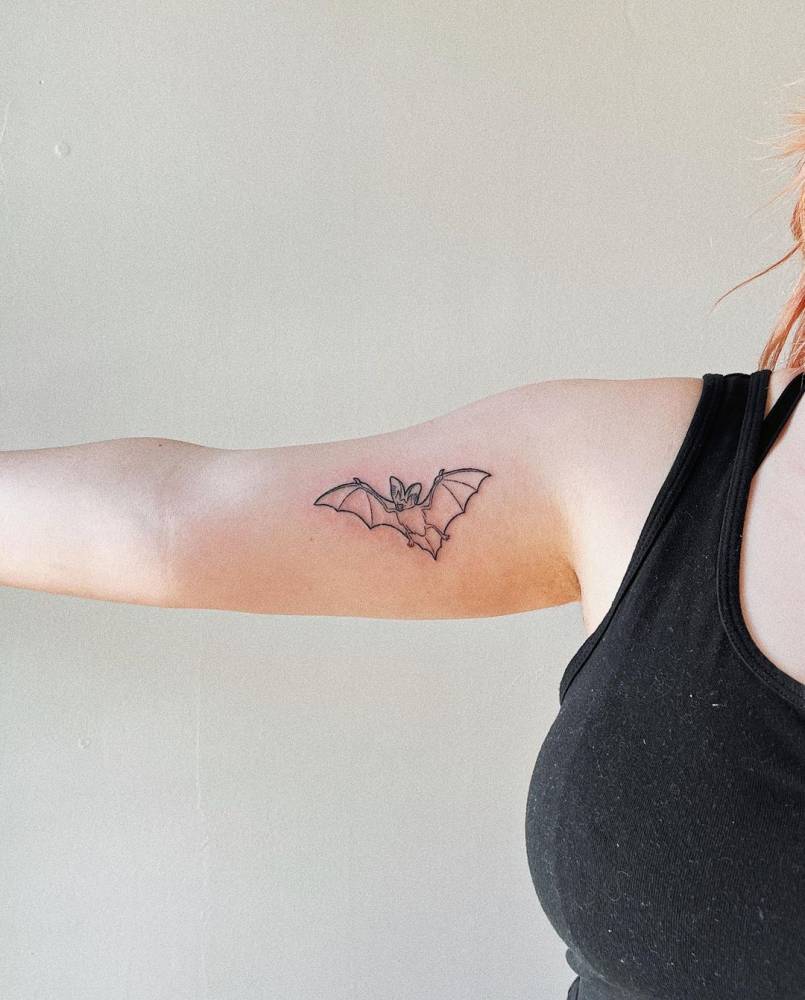 Hand poked bat tattoo done on the inner arm.