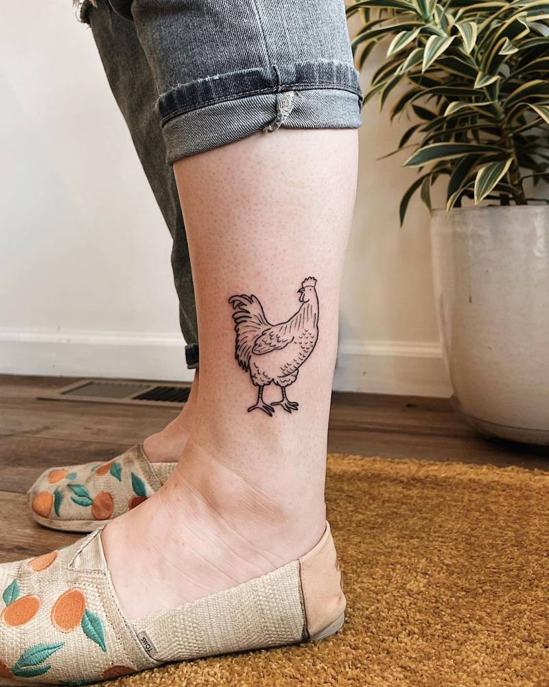 Hand poked chicken tattoo located on the ankle.
