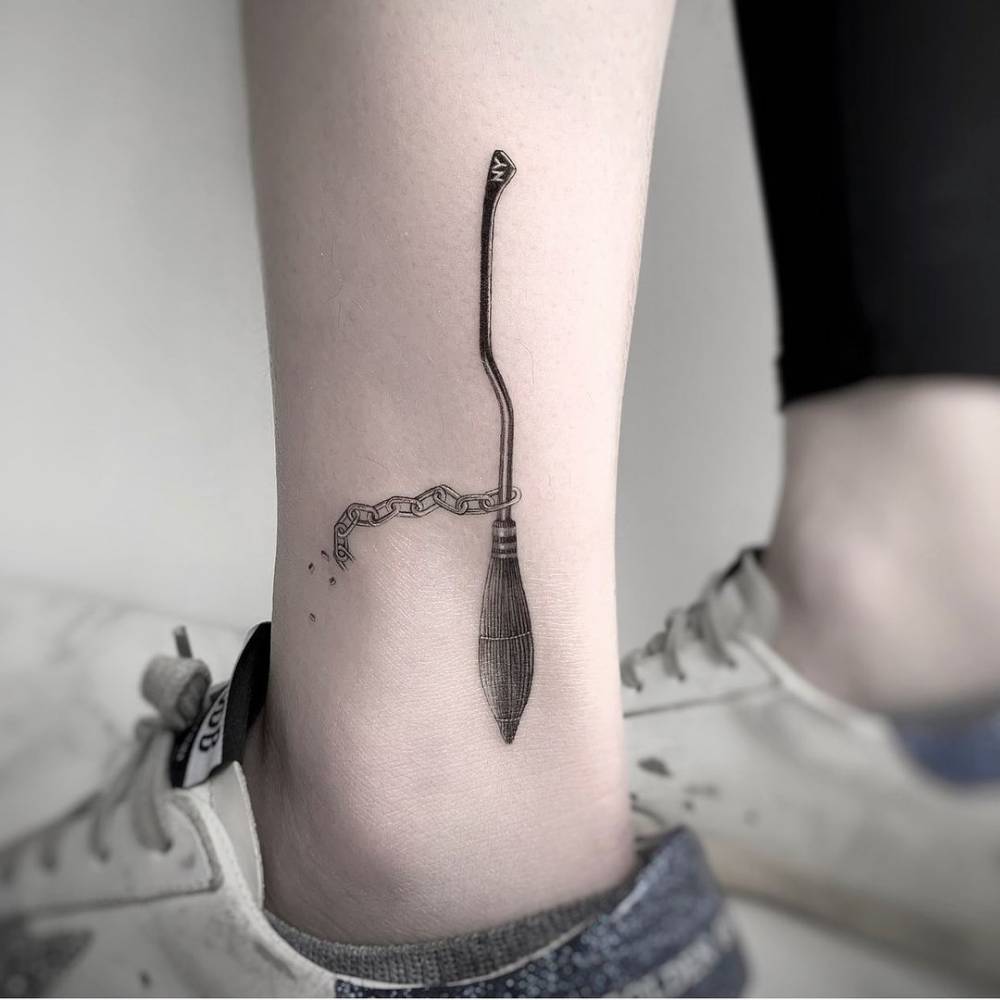 Micro-realistic Harry Potter's broom tattoo on the ankle.