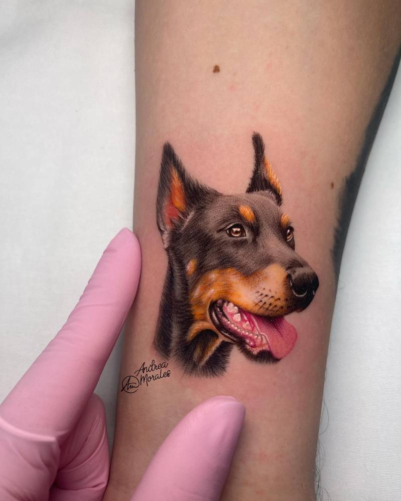 Doberman portrait in micro-realism tattooed on the wrist.