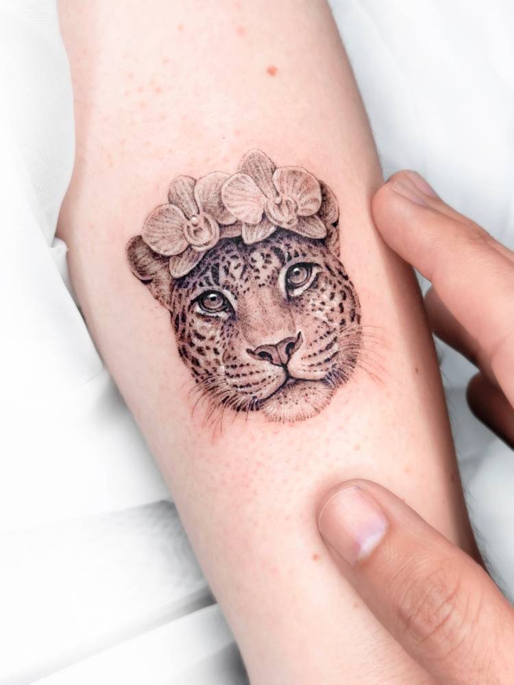 Leopard portrait tattoo in micro-realistic style done on the achilles.