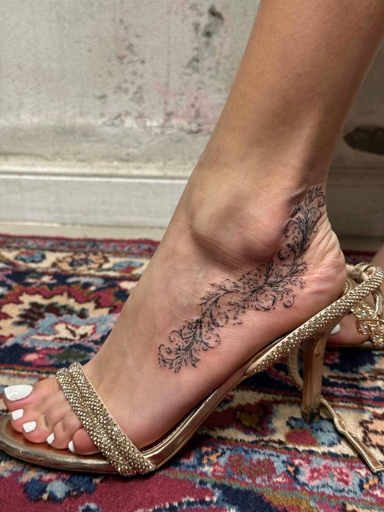 Ornamental design tattooed on the foot and ankle.
