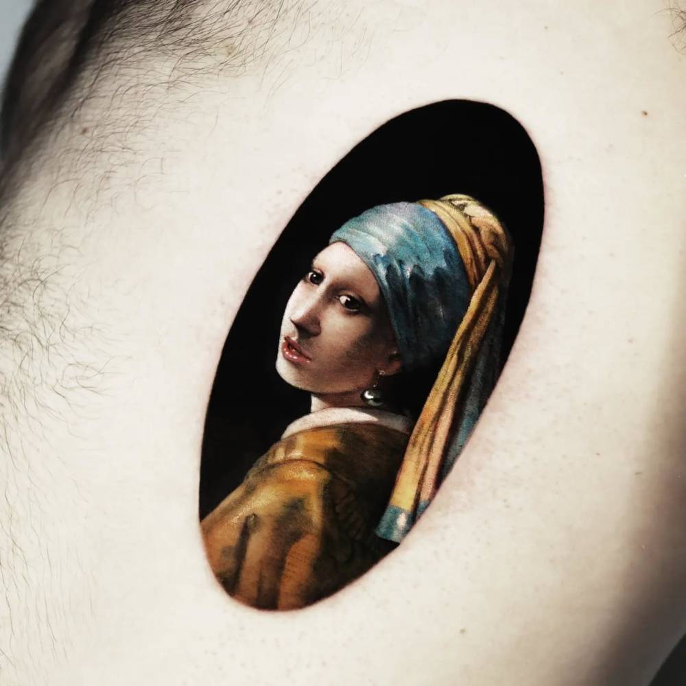 'Girl with a Pearl Earring' tattoo located on the rib.