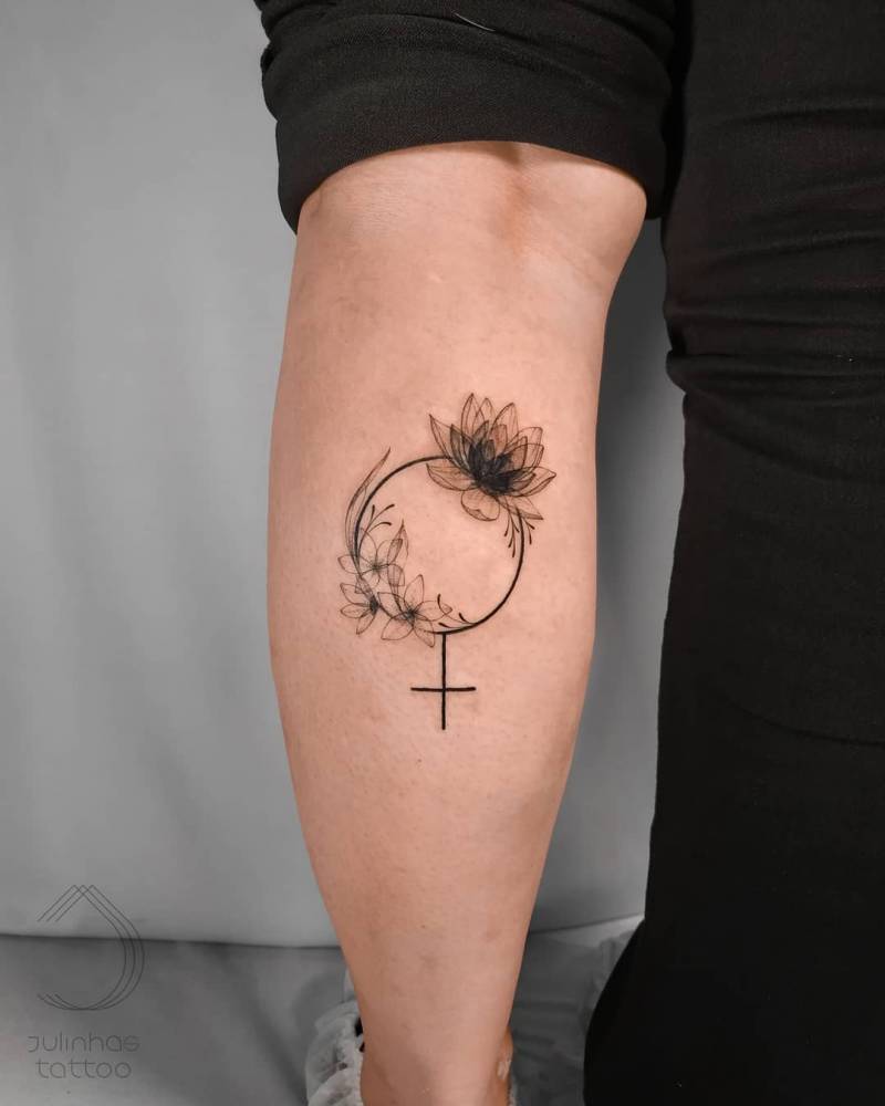 X-Ray effect floral Venus symbol tattoo located on the calf.