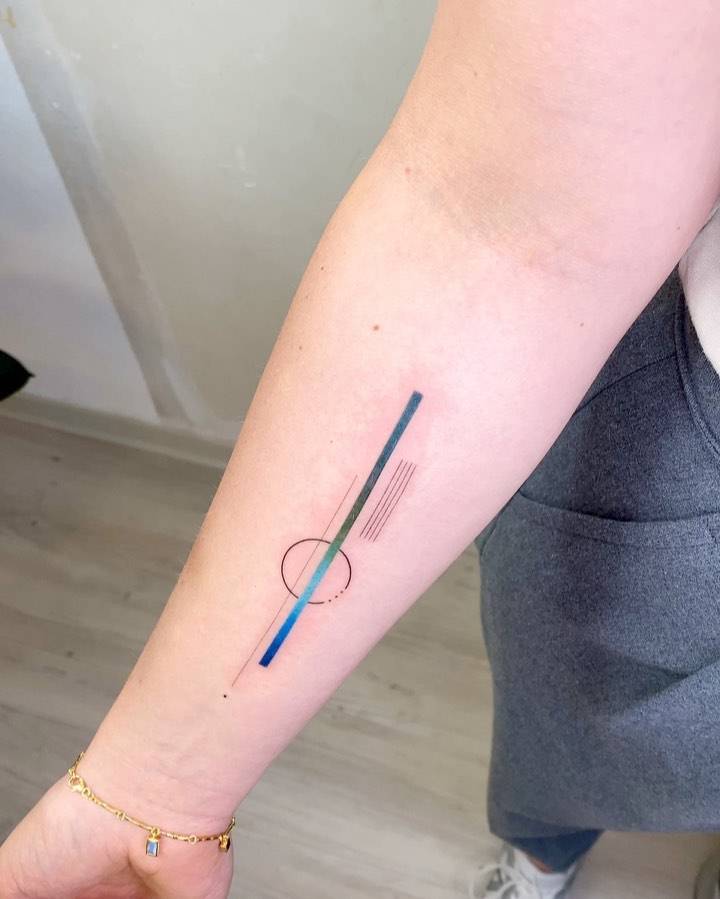 Abstract geometric tattoo located on the inner forearm.