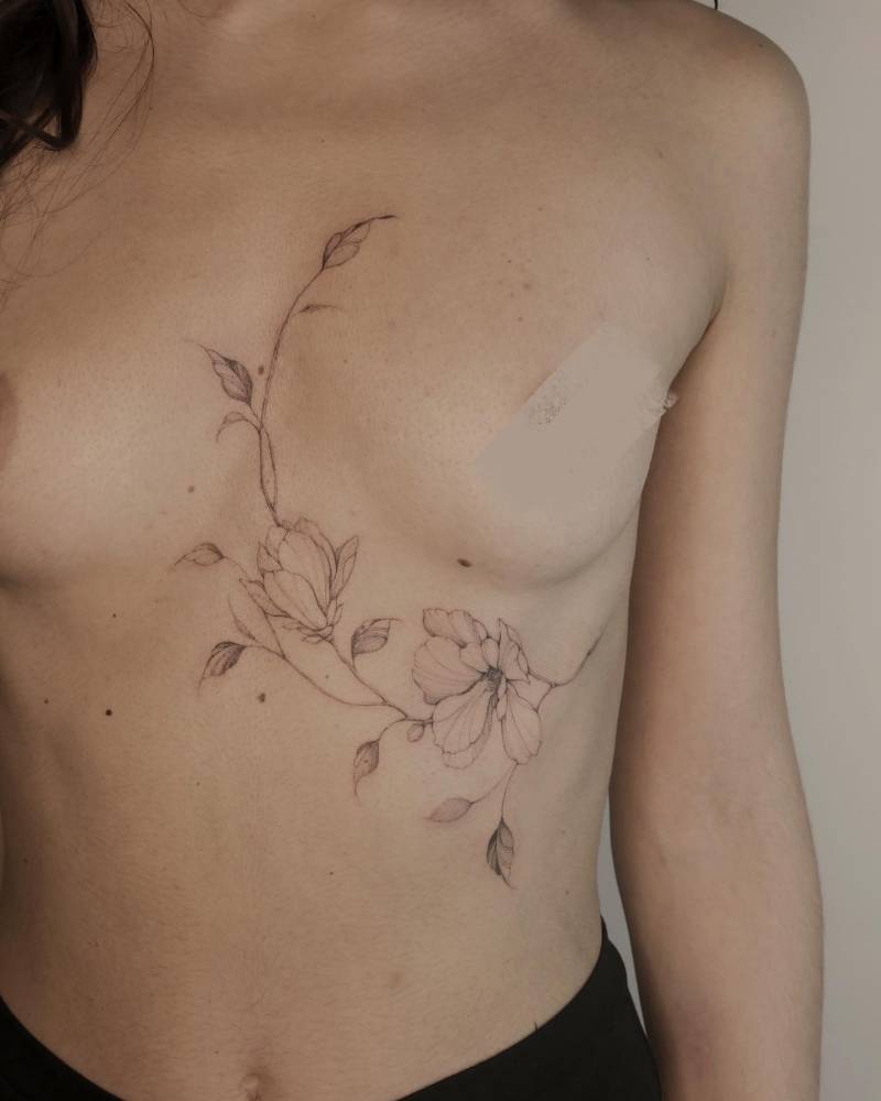 Magnolia composition tattoo located on the torso.