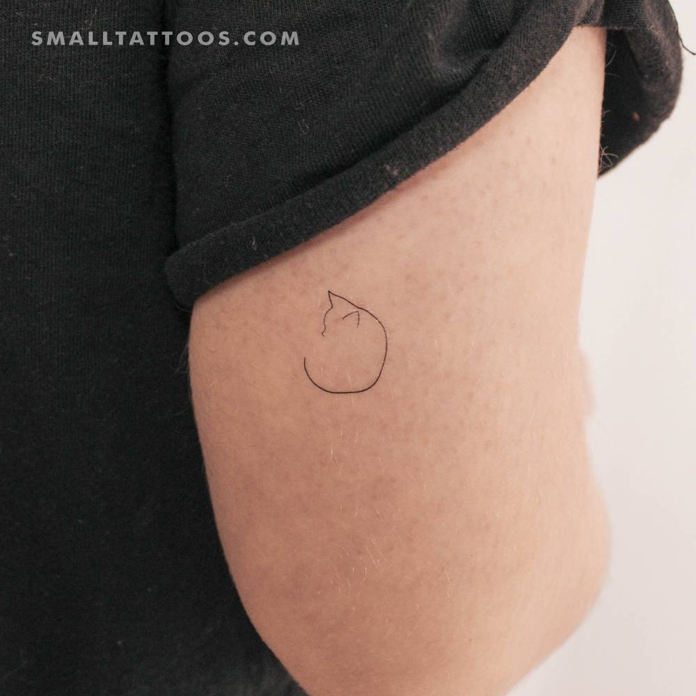 Minimalist little cat temporary tattoo located on the tricep.