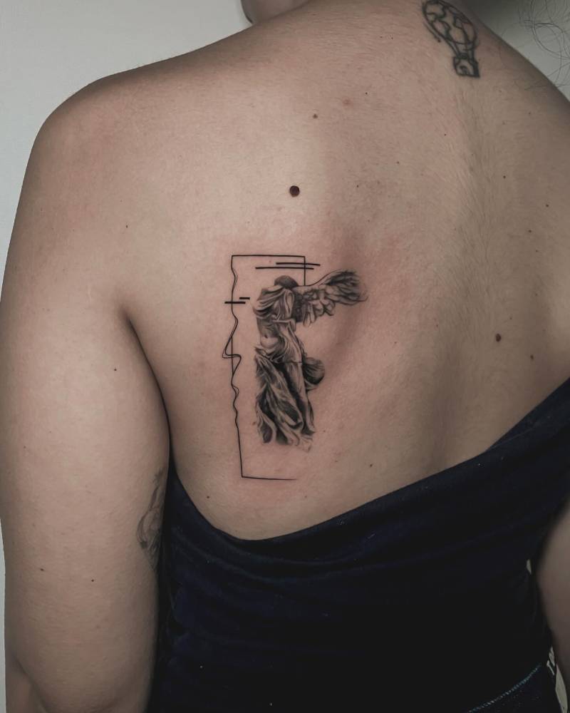 Micro-realistic style 'Singed Victory of Samothrace" tattoo done on the shoulder blade.