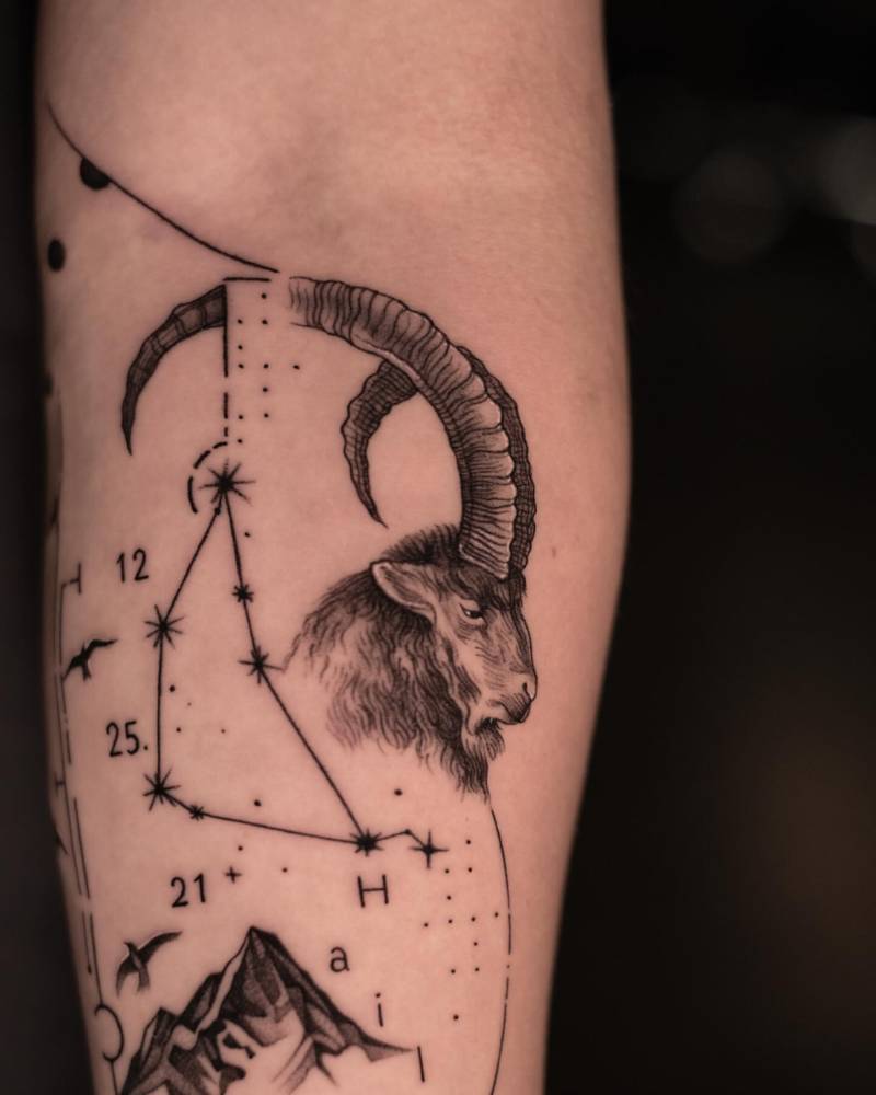 Graphic style Goat and Capricornus constellation tattooed on the inner forearm.