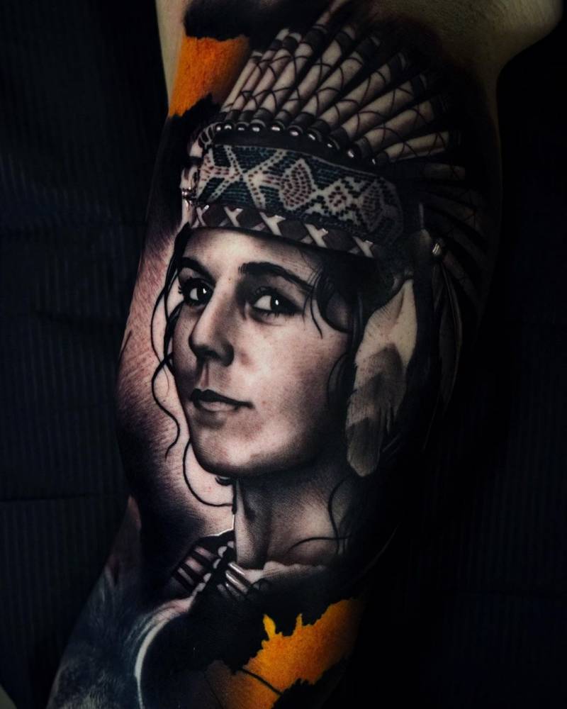 Black and grey native american woman tattoo on the inner arm.