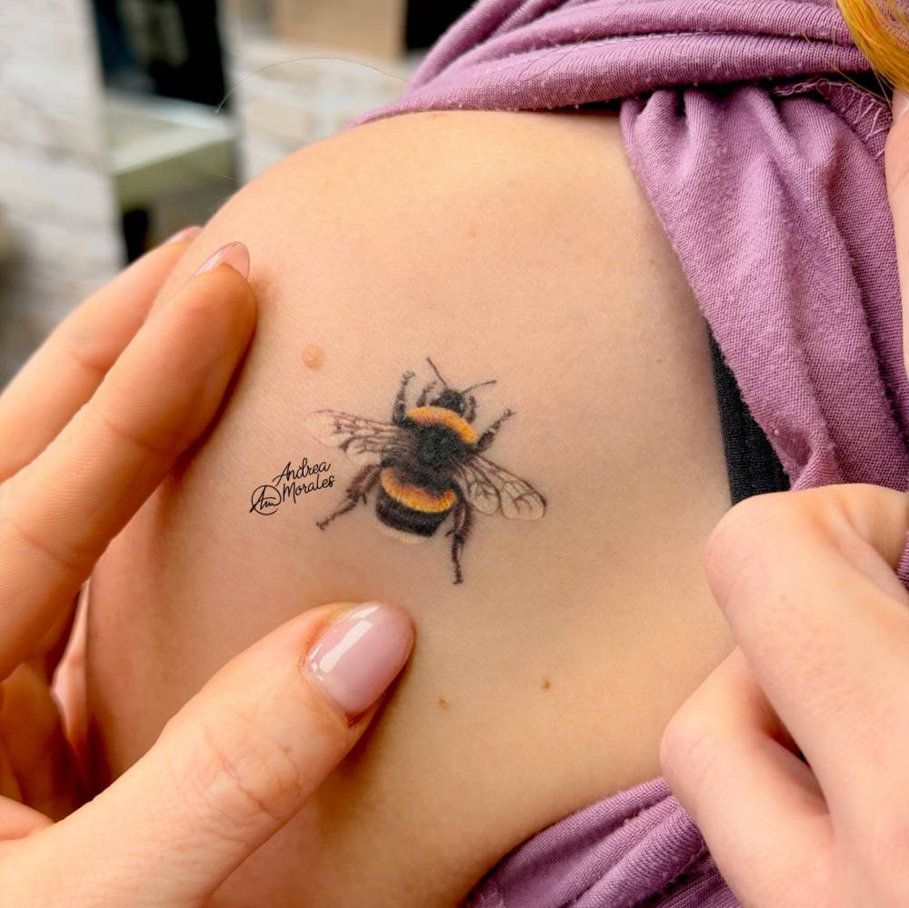 Bee tattoo located on the shoulder, done in micro-realistic style (healed).