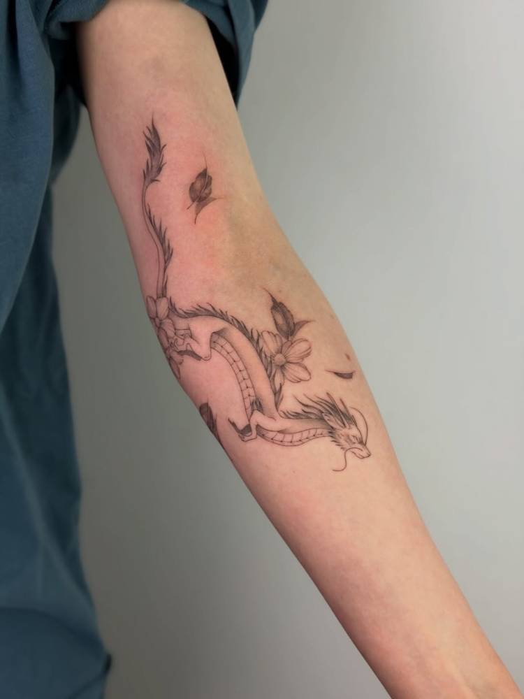 Cartoon style Haku tattoo located on the arm.