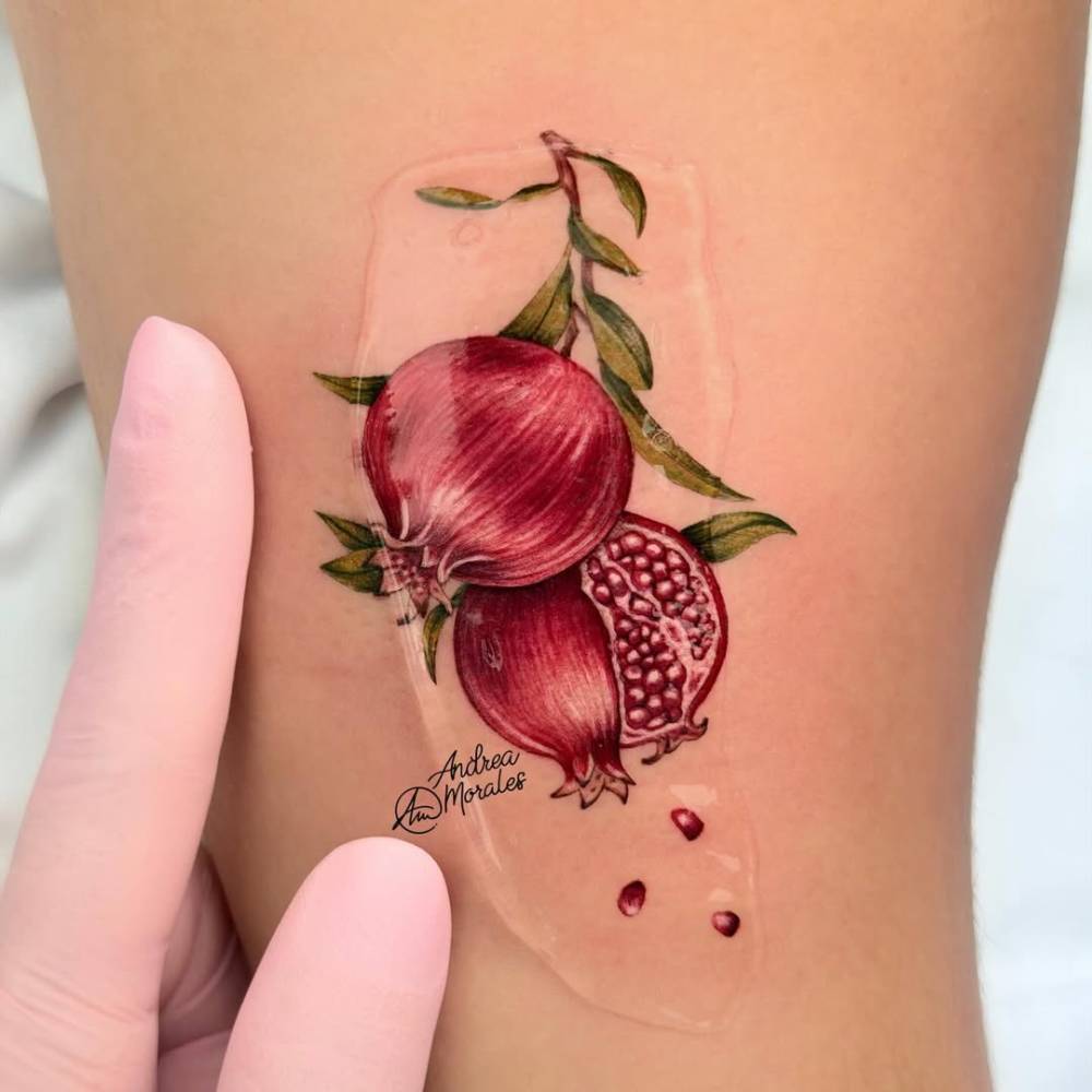 MIcro-realistic style pomegranate tattoo located on the tricep.