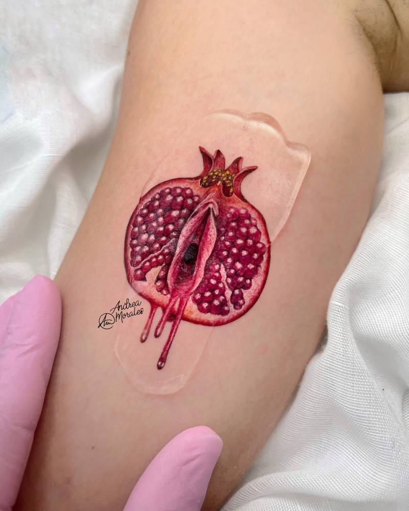 Pomegranate vagina tattoo located on the inner arm, done in micro-realism.