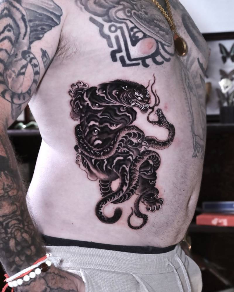 Tiger and snake battle royale tattoo in oriental style.
