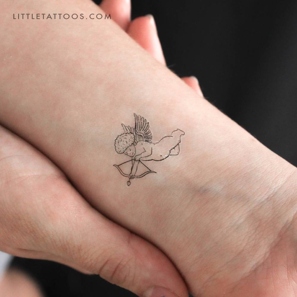 Cupid temporary tattoo in fine line style located on the wrist.