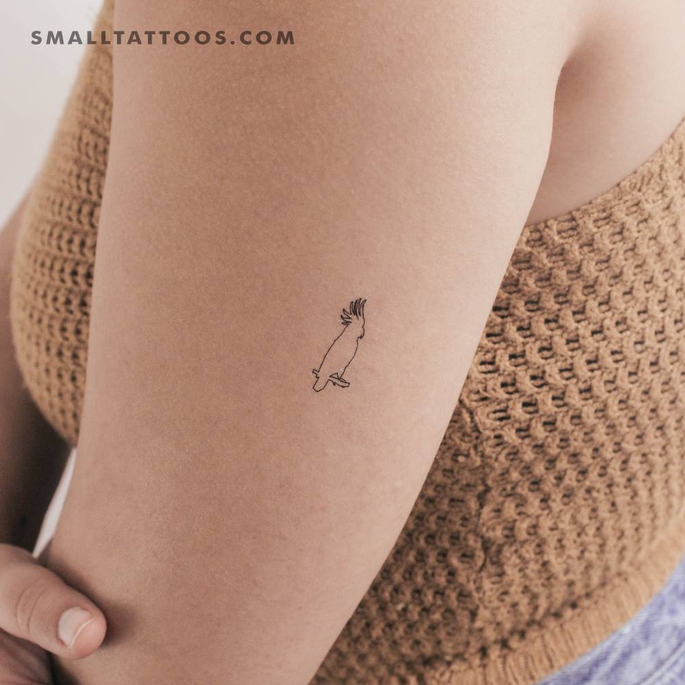 Fine line style cockatoo temporary tattoo located on the tricep.