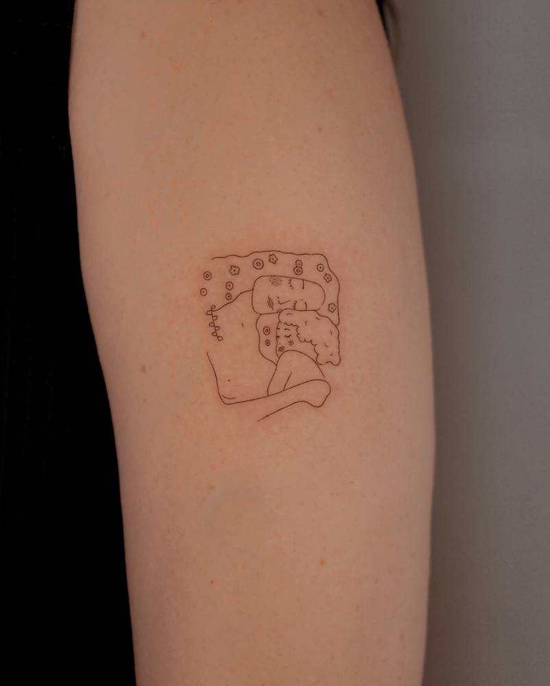 Fine line style 'The Three Ages of Woman' tattoo located on the upper arm.