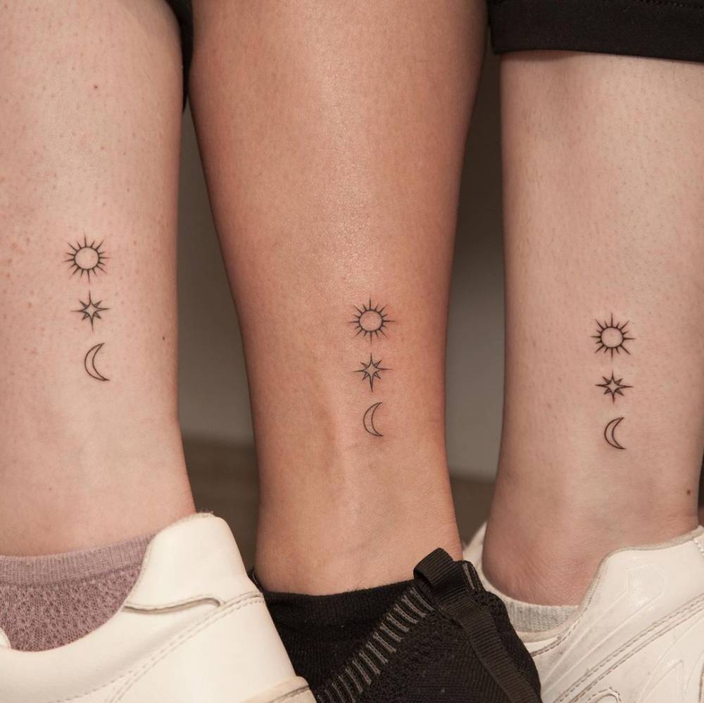 Matching sun, moon and star tattoos for mother and daughters.