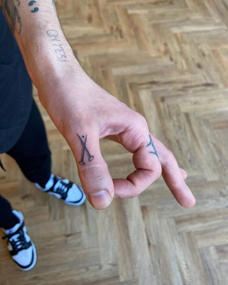 Micro-realistic nails tattoo located on the thumb.