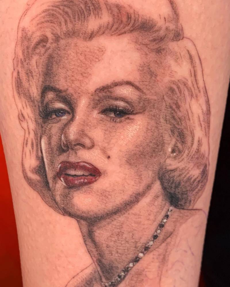 Realistic portrait tattoo of Marilyn Monroe done on the inner forearm.