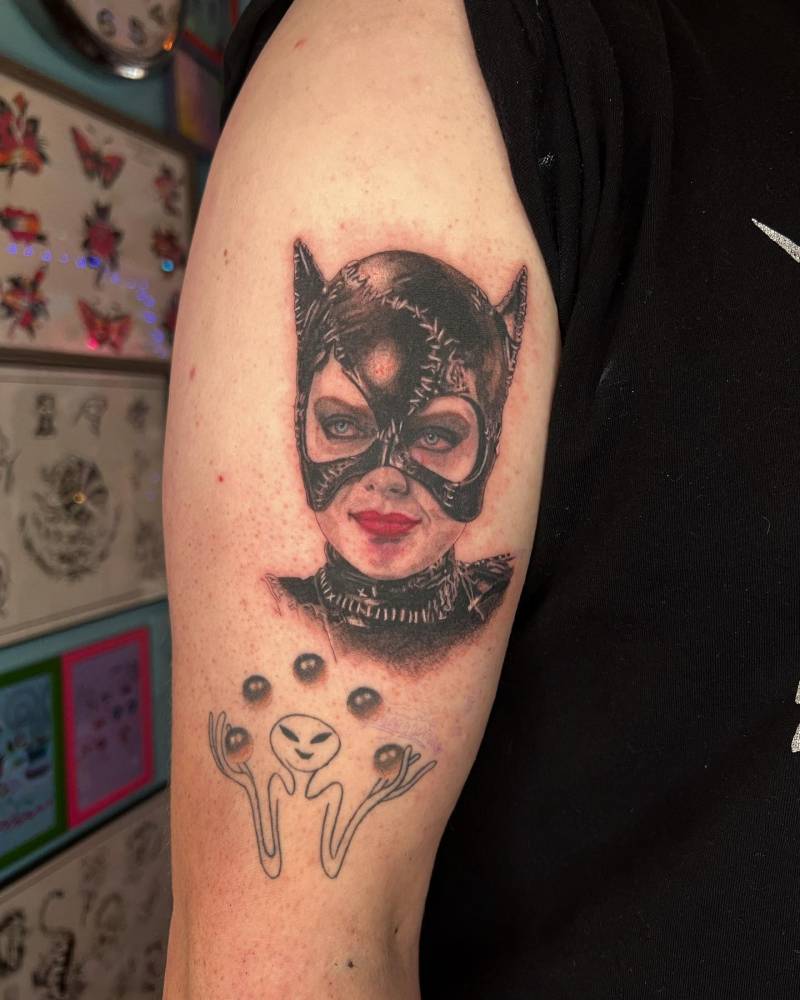 Catwoman portrait tattoo located on the upper arm.