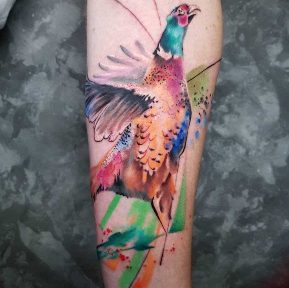 Colorful pheasant tattoo done on the inner forearm.