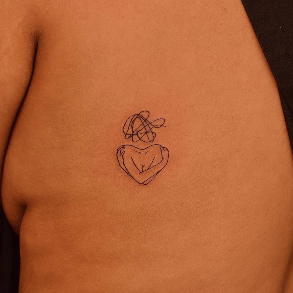 Self love tattoo located on the rib, fine line style.