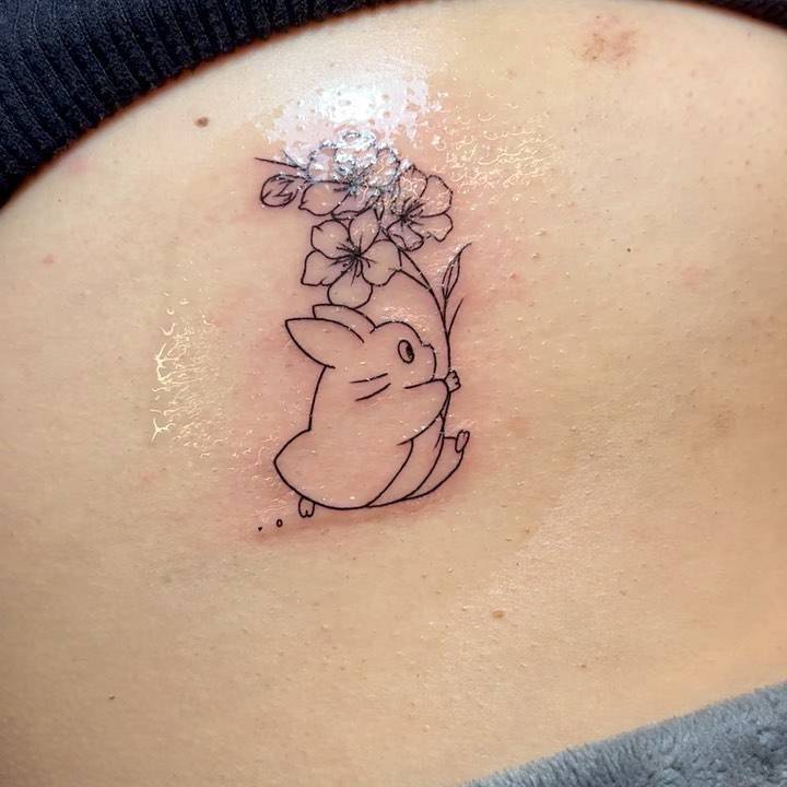 Fine line style Chuu Totoro tattoo located on the rib.