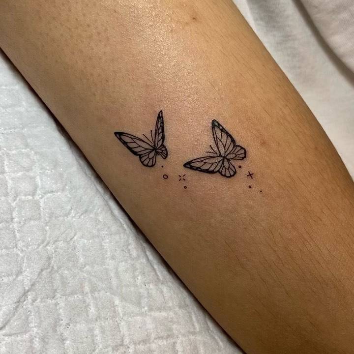 Butterfly couple tattoo located on the upper arm.