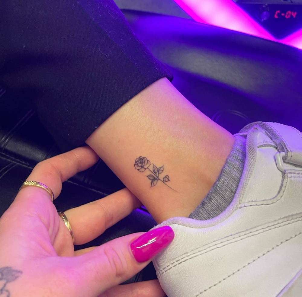 Rose tattoo placed on the ankle, done in fine line style.