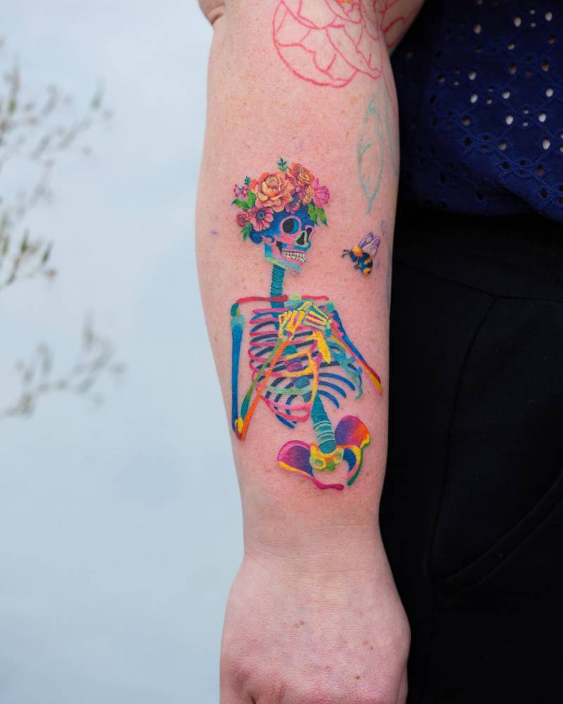Colorful skeleteon tattoo located on the forearm.