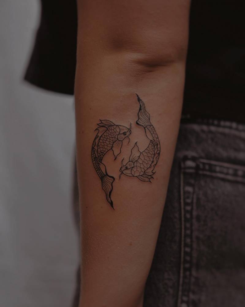 Fine line style koi fish tattoo located on the forearm.