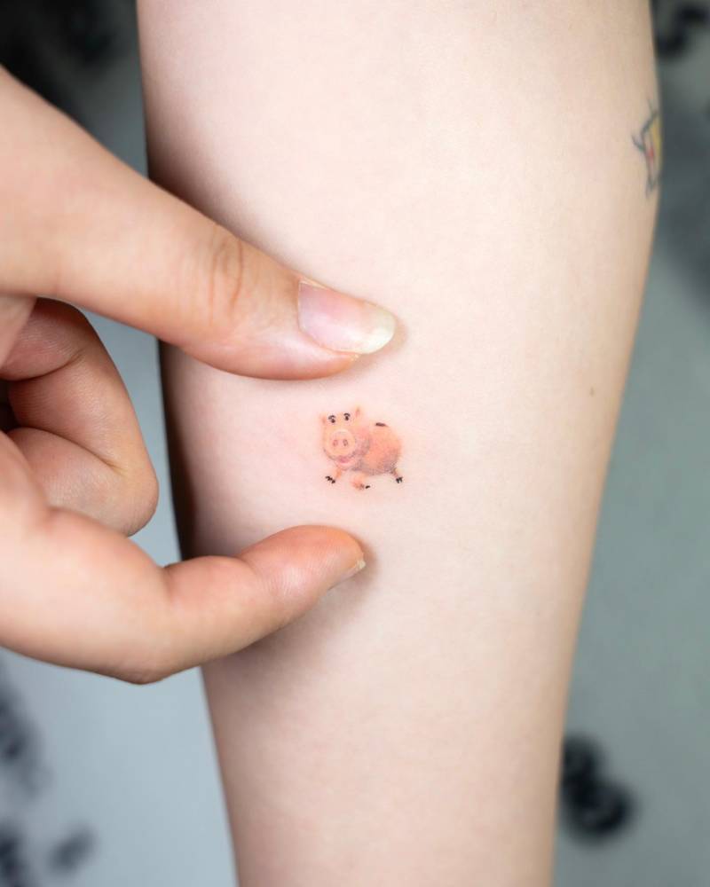 Cartoon style Hamm tattoo located on the inner forearm.